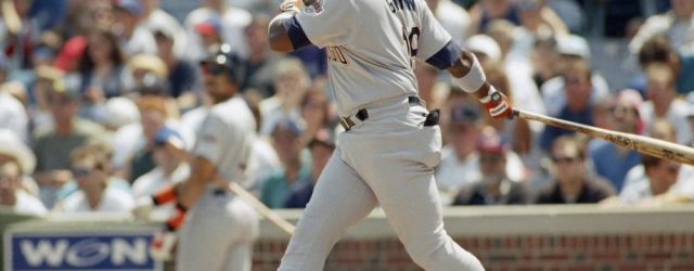 Tony Gwynn swings and hits a baseball