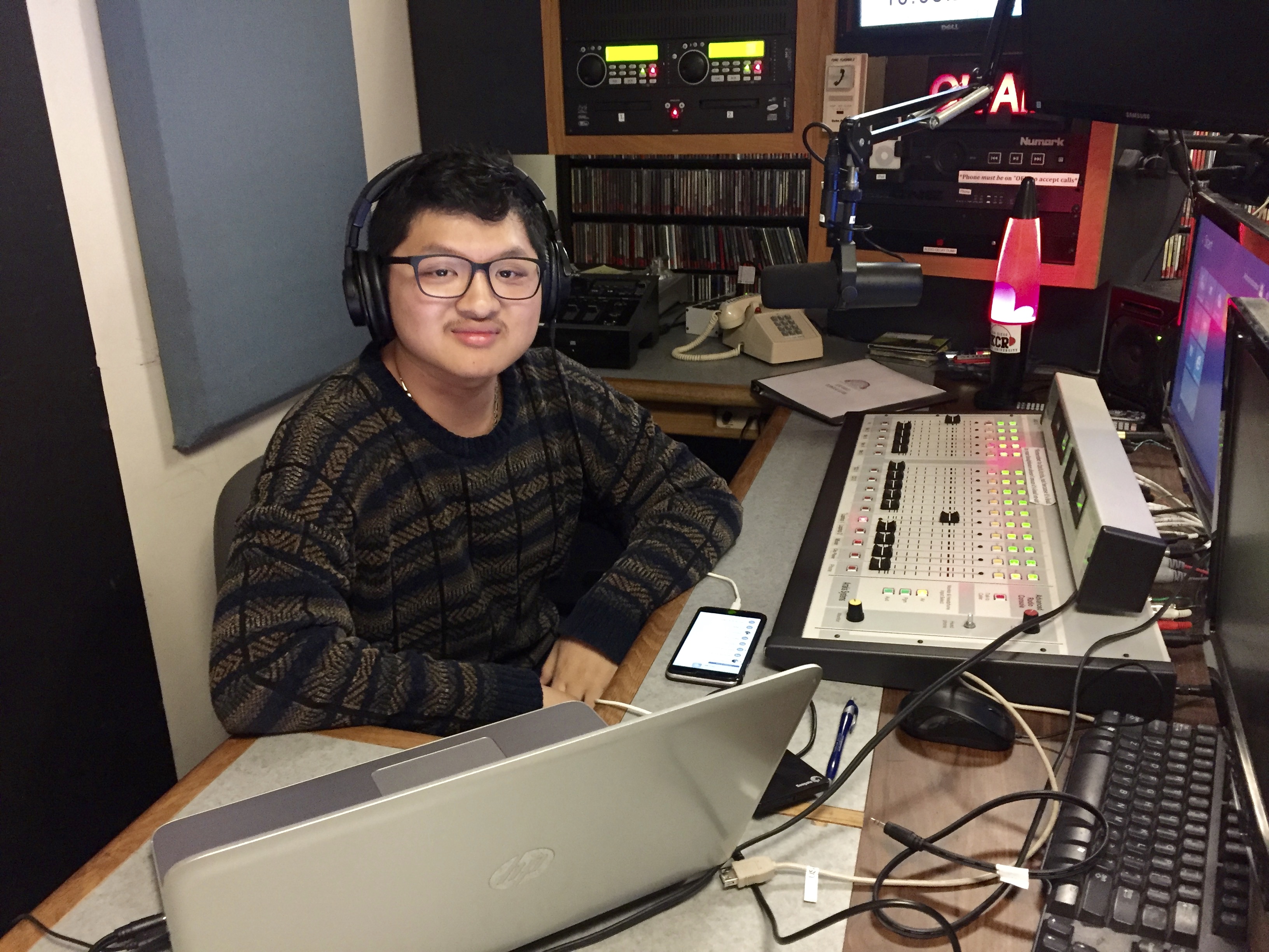 Christian Le, a music DJ at KCR, begins his playlist for the night in the studio.
