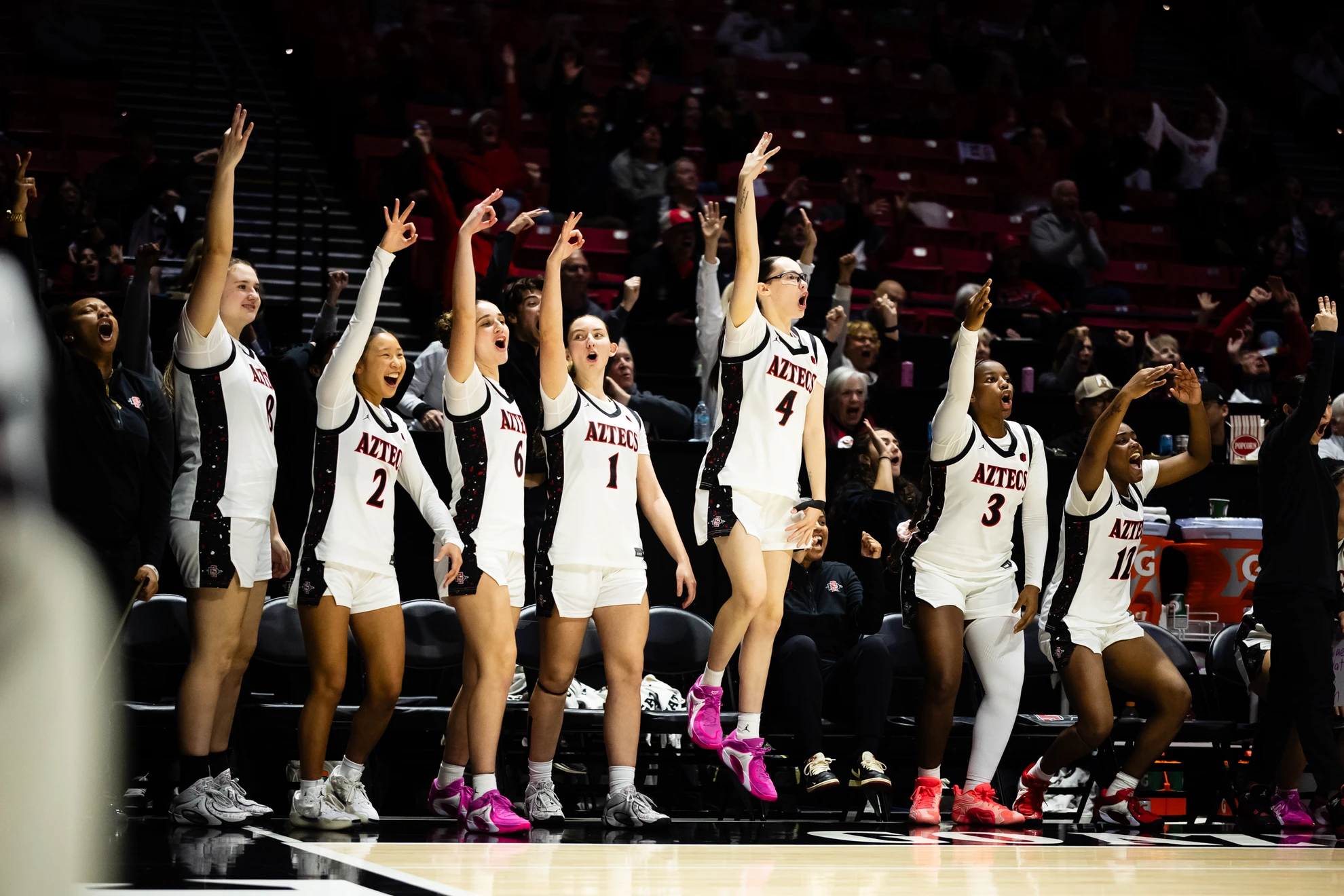 The Aztec bench celebrates a three-pointer against UNLV.